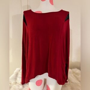Eloquii red top with black cold shoulder dolman style sleeves.